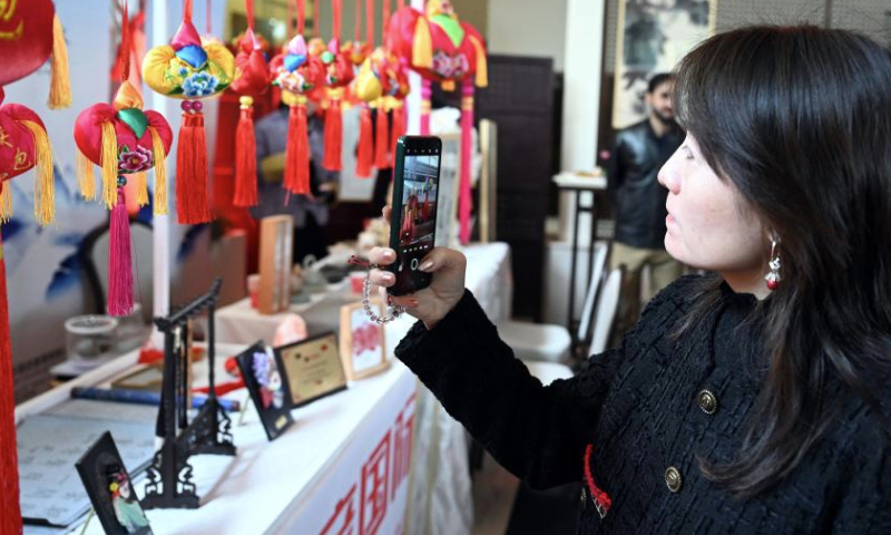 A woman visits a decorations stall during an event welcoming the Chinese New Year in Islamabad, capital of Pakistan, on Jan. 11, 2025. An event welcoming the Chinese New Year, or Spring Festival, was held here on Saturday, with over 500 overseas Chinese and Pakistani guests participating. (Xinhua/Ahmad Kamal)