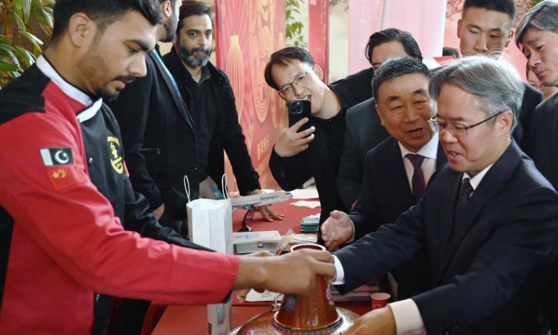 Chinese Ambassador to Pakistan Jiang Zaidong visits a stall during an event welcoming the Chinese New Year in Islamabad, capital of Pakistan, on Jan. 11, 2025. An event welcoming the Chinese New Year, or Spring Festival, was held here on Saturday, with over 500 overseas Chinese and Pakistani guests participating. (Xinhua/Ahmad Kamal)