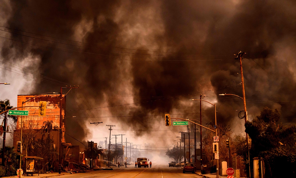 Smoke and flames overwhelm a commercial area during the Eaton fire in the Altadena area of Los Angeles County, California on January 8, 2025. At least five people are now known to have died in wildfires raging around Los Angeles, with more deaths feared, law enforcement said January 8, as terrifying blazes leveled whole streets, torching cars and houses in minutes. Photo: VCG