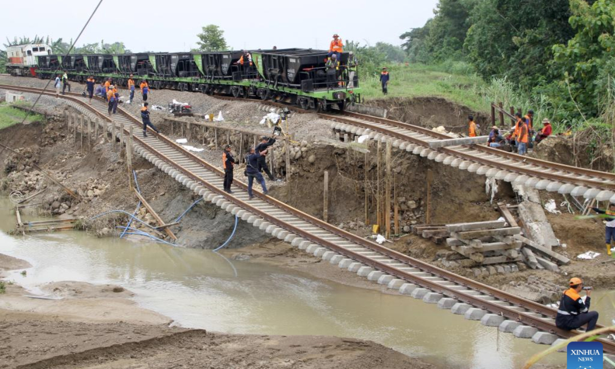 People work near damaged railways after flash flood in Grobogan regency, Central Java, Indonesia, Jan. 22, 2025. (Photo by Bram Selo/Xinhua)