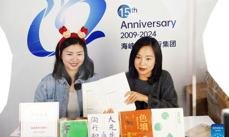 Staff members promote books via live streaming during the 2025 Beijing Book Fair in Beijing, capital of China, Jan. 9, 2025. The 2025 Beijing Book Fair opened on Thursday at the China International Exhibition Center, with over 400,000 titles on display, according to the organizers. (Xinhua/Pan Xu)