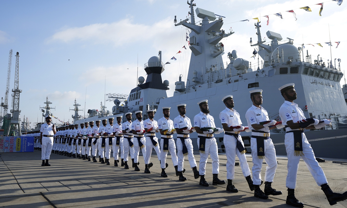 Pakistan Naval personal carry national flags of participating countries during the opening ceremony of Pakistan Navy's Multinational Exercise AMAN-23 (PEACE), in Karachi, Pakistan, on February 10, 2023. Photo: VCG