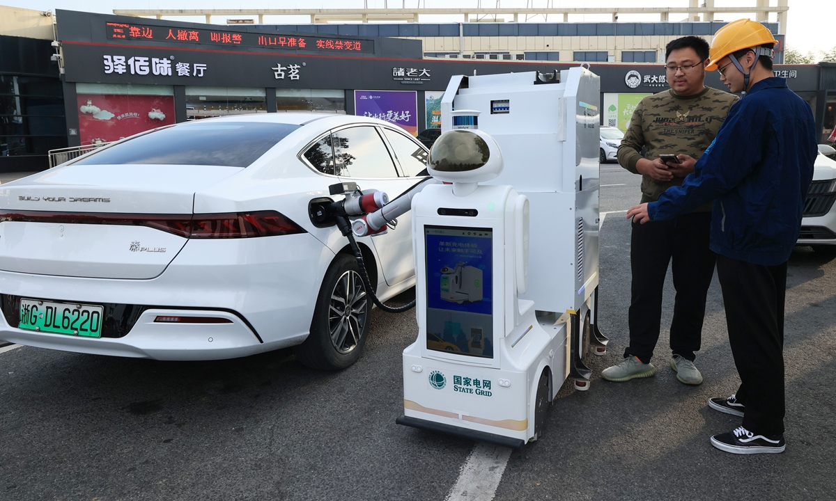 An intelligent charging robot charges a new energy vehicle at a service area in Jinhua, East China's Zhejiang Province, on January 14, 2025. Photo: VCG