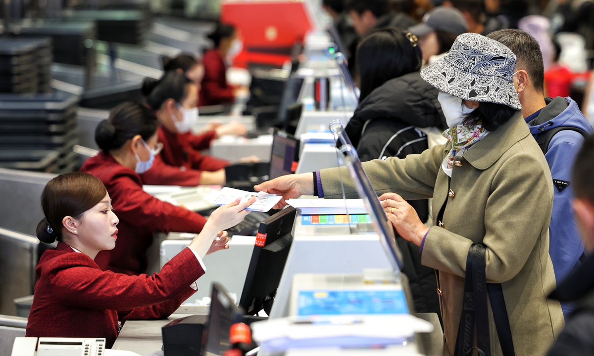 Passengers line up to check in at the Beijing Capital International Airport on January 14, 2025. Photo: VCG