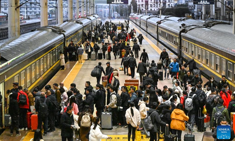 Passengers line up to board their trains at the Wuchang Railway Station in Wuhan, central China's Hubei Province, Jan. 25, 2025.