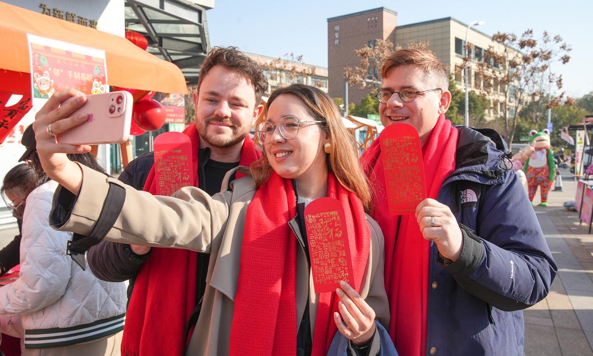 Foreign visitors experience traditional Chinese New Year customs in Huzhou, East China's Zhejiang Province on January 18, 2025. Photo: VCG