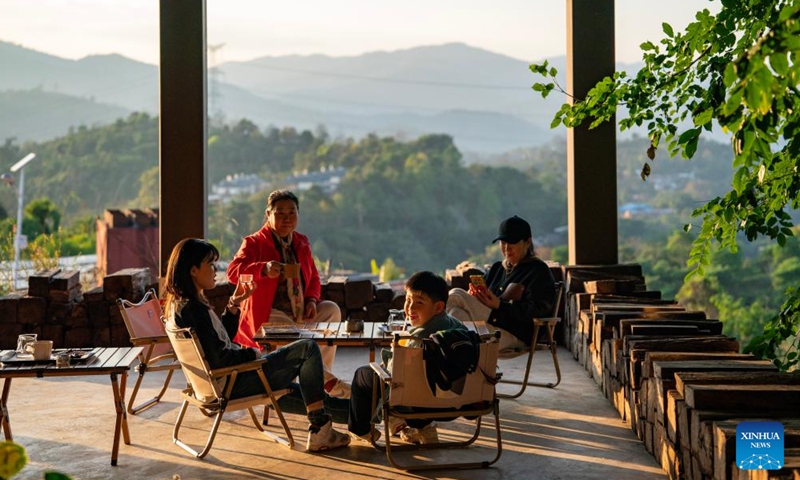 Tourists relax at a coffee manor in Pu'er, southwest China's Yunnan Province, Jan. 7, 2025. 