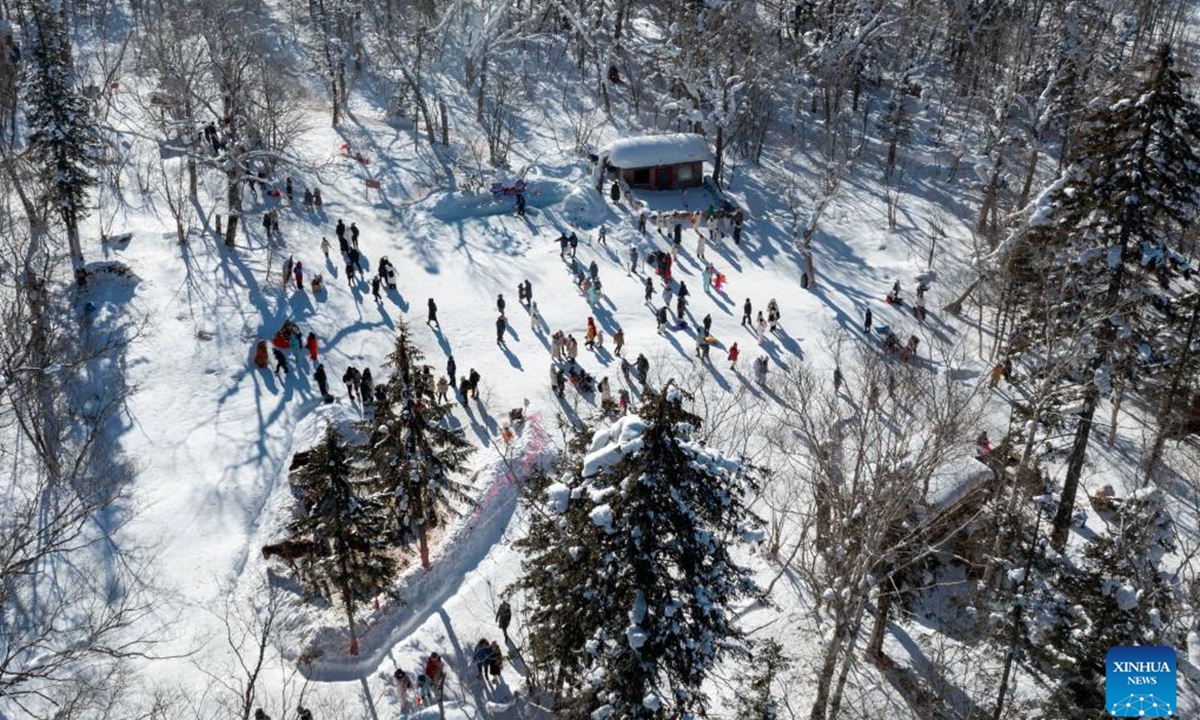 An aerial drone photo taken on Jan. 25, 2025 shows visitors having fun at an ice and snow scenic spot along the Yaxue Road in Dunhua of Yanbian Korean Autonomous Prefecture, northeast China's Jilin Province. As part of national highway G333, Yaxue Road connects Harbin, Yabuli, and Snow Town, all of them iconic winter tourist attractions in northeast China, offering visitors the natural and cultural charm of the region. (Xinhua/Xie Jianfei)



