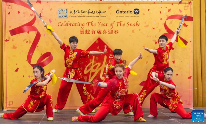 Children interact with lion dancers in celebration of the upcoming Spring Festival, or the Chinese Lunar New Year, at the Chinese Cultural Center of Greater Toronto in Toronto, Canada, Jan. 26, 2025. (Photo by Zou Zheng/Xinhua)