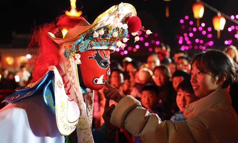 A Sichuan Opera performer interacts with spectators in Qianjiang District, southwest China's Chongqing Municipality, Jan. 26, 2025. China is alive with vibrant celebrations with the Spring Festival just around the corner. (Photo by Yang Min/Xinhua)