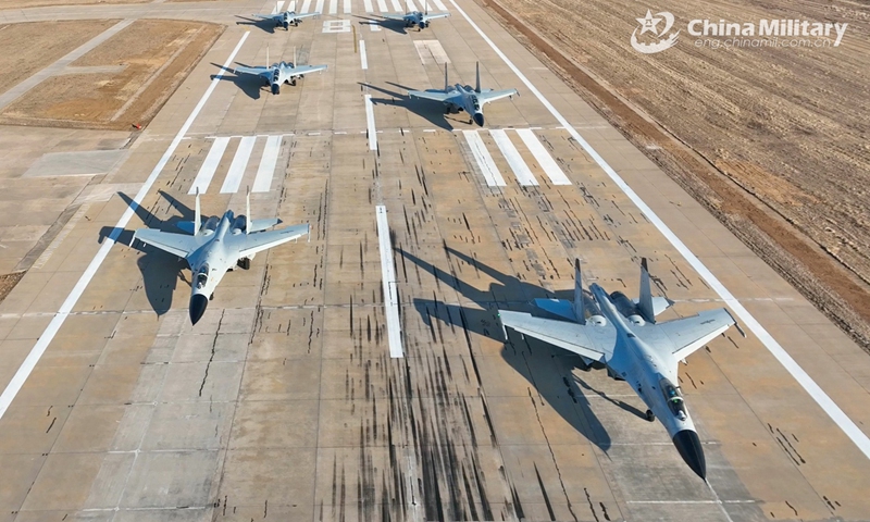 J-11BS fighter jets attached to the Chinese PLA Naval Aviation University taxi on the runway during a force-on-force flight training exercise on January 4, 2025. (eng.chinamil.com.cn/Photo by Zhang Zhiguang)