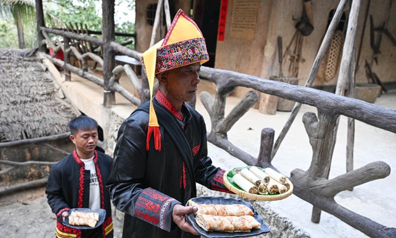 Villagers serve traditional snacks at Binglanggu tourism area in Baoting Li and Miao Autonomous County, south China's Hainan Province, Jan. 28, 2025. An event featuring Li ethnic group culture was held at Binglanggu tourism area to celebrate the Chinese New Year, where tourists could dress in traditional Li attire and taste food with Li characteristics. Photo: Xinhua