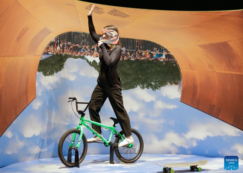 A woman stands on a freestyle BMX bike during a media preview of the Extreme Sports: Beyond Human Limits exhibition in Vancouver, British Columbia, Canada, on Jan. 30, 2025. Showcasing some of the most extreme sports in the world, including mountain climbing, skydiving, and deep-sea diving, the exhibition runs from Jan. 31 to May 19, 2025. Photo: Xinhua