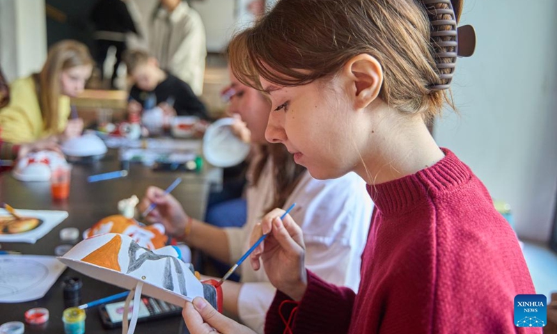 Participants paint Beijing Opera masks during an event in celebration of the Chinese New Year at the Confucius Institute of Far Eastern Federal University of Russia, in Vladivostok, Russia, Jan. 29, 2025. The Confucius Institute of Far Eastern Federal University of Russia hosted a Chinese New Year cultural experience event, attracting many participants. Photo: Xinhua