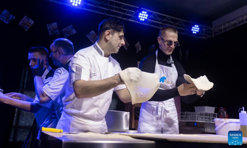 Participants make pizza during the 18th International Specialised Fairs of Tastes in Ljubljana, Slovenia, Jan. 29, 2025. Photo: Xinhua