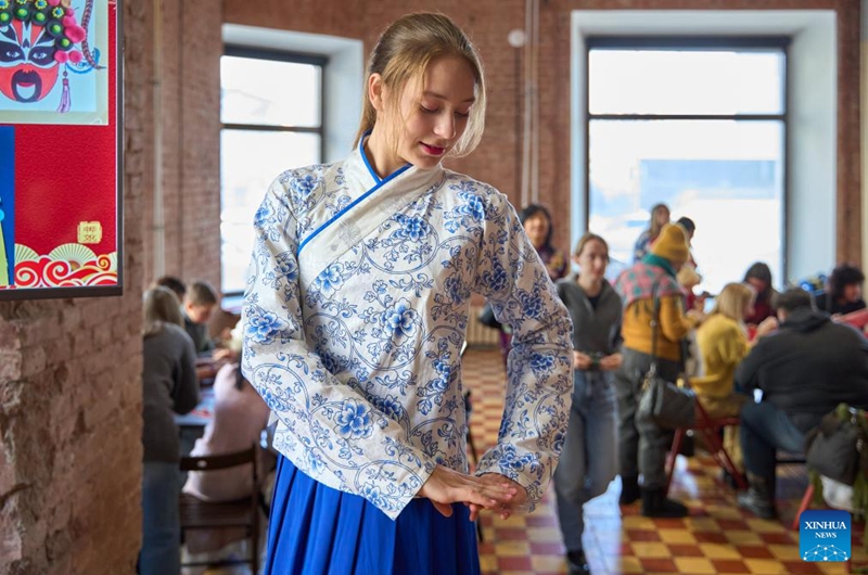 A participant tries on traditional Chinese costume during an event in celebration of the Chinese New Year at the Confucius Institute of Far Eastern Federal University of Russia, in Vladivostok, Russia, Jan. 29, 2025. The Confucius Institute of Far Eastern Federal University of Russia hosted a Chinese New Year cultural experience event, attracting many participants. Photo: Xinhua