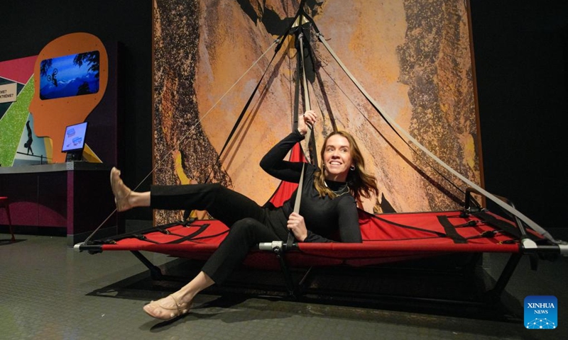 A woman tries out a sleeping pad used in rock climbing during a media preview of the Extreme Sports: Beyond Human Limits exhibition in Vancouver, British Columbia, Canada, on Jan. 30, 2025. Showcasing some of the most extreme sports in the world, including mountain climbing, skydiving, and deep-sea diving, the exhibition runs from Jan. 31 to May 19, 2025. Photo: Xinhua