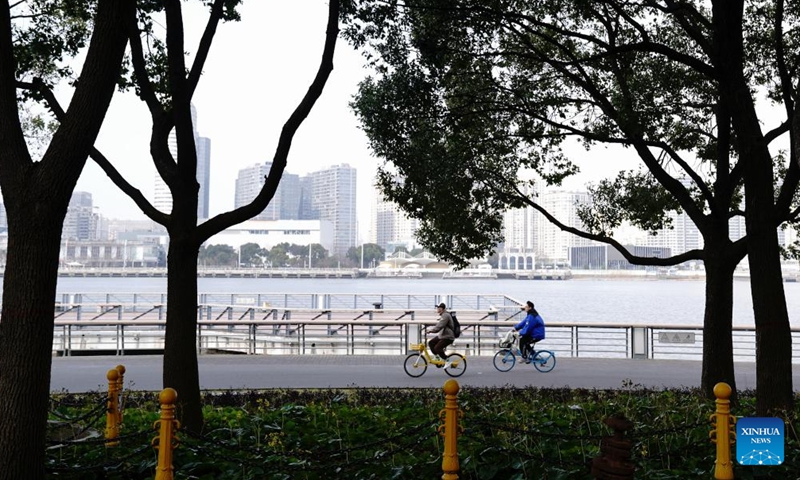 People ride bikes at Shanghai's World Expo culture park during the Spring Festival holiday in Shanghai, east China, Feb. 3, 2025. (Xinhua/Zhang Jiansong)