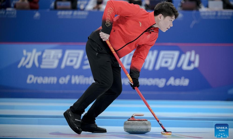 Wang Zhiyu of China competes during the mixed doubles Round Robin Session 1 match between Amina Seitzhanova/Azizbek Nadirbayev of Kazakhstan and Han Yu/Wang Zhiyu of China in the curling event at 2025 Asian Winter Games in Harbin, northeast China's Heilongjiang Province, Feb. 4, 2025. Photo: Xinhua