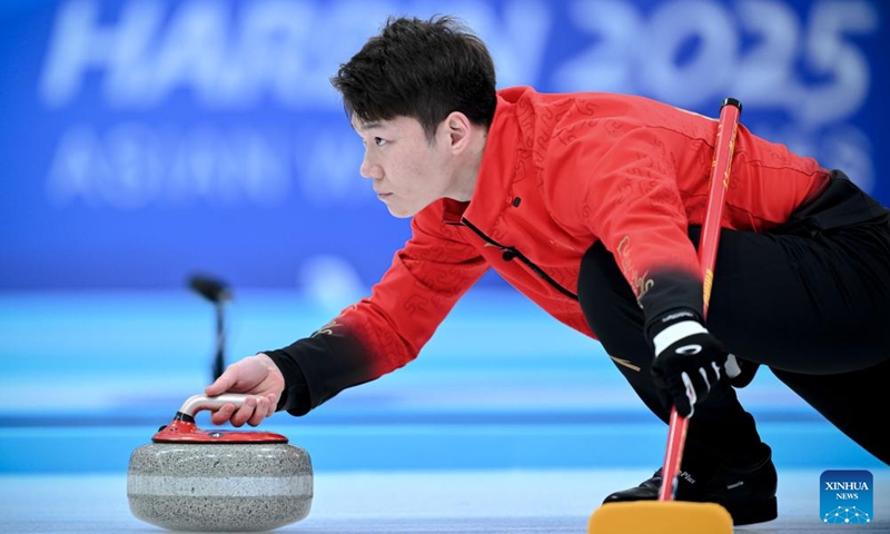 Wang Zhiyu of China competes during the mixed doubles Round Robin Session 1 match between Amina Seitzhanova/Azizbek Nadirbayev of Kazakhstan and Han Yu/Wang Zhiyu of China in the curling event at 2025 Asian Winter Games in Harbin, northeast China's Heilongjiang Province, Feb. 4, 2025. Photo: Xinhua