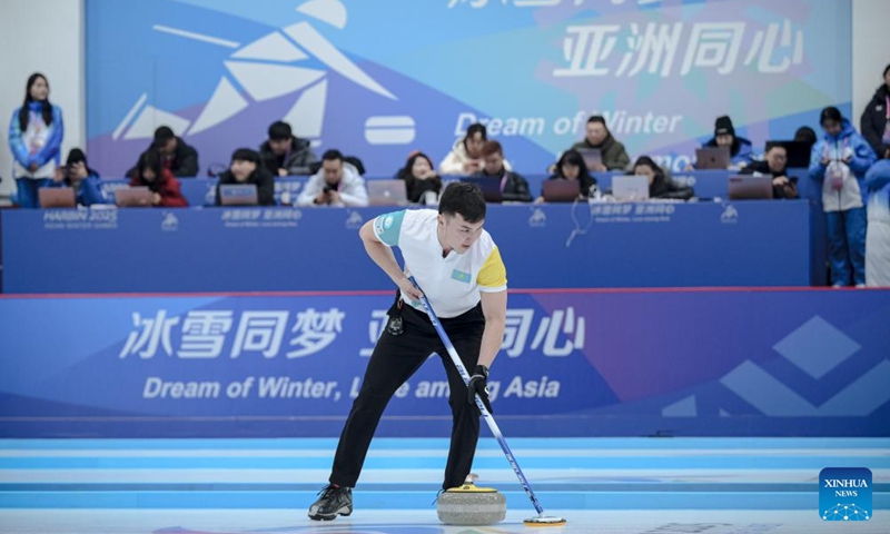 Azizbek Nadirbayev of Kazakhstan competes during the mixed doubles Round Robin Session 1 match between Amina Seitzhanova/Azizbek Nadirbayev of Kazakhstan and Han Yu/Wang Zhiyu of China in the curling event at 2025 Asian Winter Games in Harbin, northeast China's Heilongjiang Province, Feb. 4, 2025. Photo: Xinhua