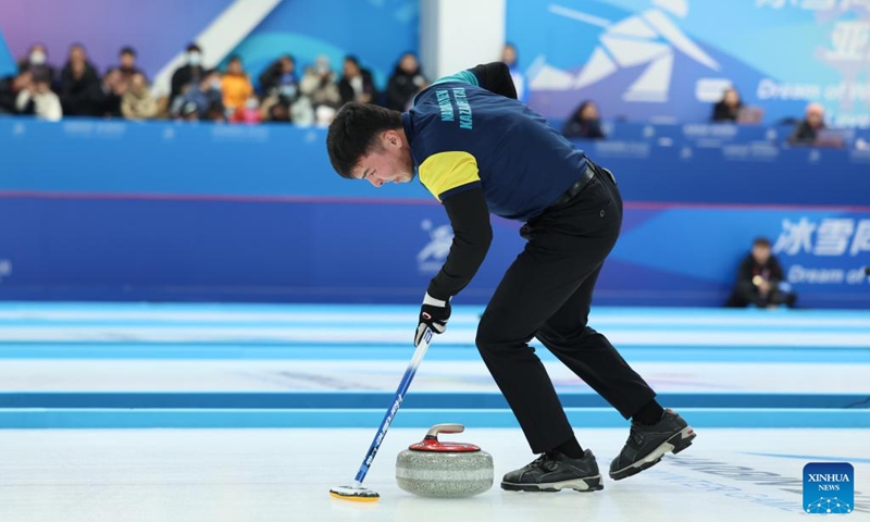 Azizbek Nadirbayev competes during the mixed doubles Round Robin Group B Session 5 match between Mabarka Salem Al-Abdulla/Nasser Abdulrahman Alyafei of Qatar and Amina Seitzhanova/Azizbek Nadirbayev of Kazakhstan in the curling event at 2025 Asian Winter Games in Harbin, northeast China's Heilongjiang Province, Feb. 5, 2025. Photo: Xinhua