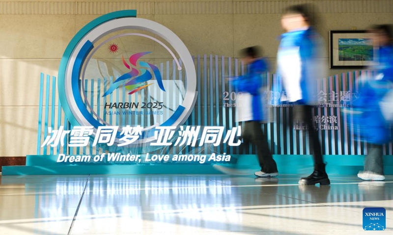 Volunteers pass an installation for the 2025 Asian Winter Games at the main press center in the Main Media Center (MMC) in Harbin, northeast China's Heilongjiang Province, Feb. 5, 2025. Photo: Xinhua