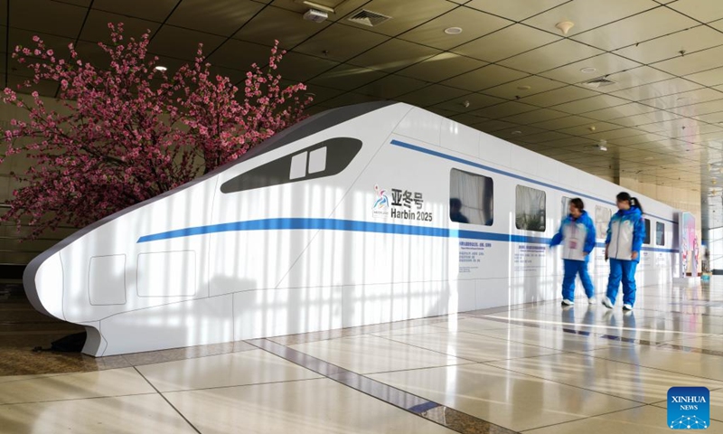 Volunteers pass an installation for the 2025 Asian Winter Games at the main press center in the Main Media Center (MMC) in Harbin, northeast China's Heilongjiang Province, Feb. 5, 2025. Photo: Xinhua