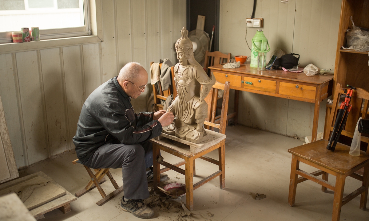 A senior sculptor makes a warrior statue at the Qufu Glazed Tile Factory. Photo: Shan Jie/GT