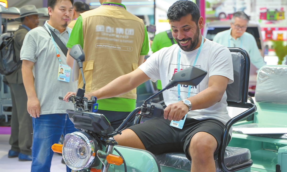 A customer experiences an electric tricycle at the 135th China Import and Export Fair held in Guangzhou, Guangdong Province, on April 15, 2024. Photo: VCG