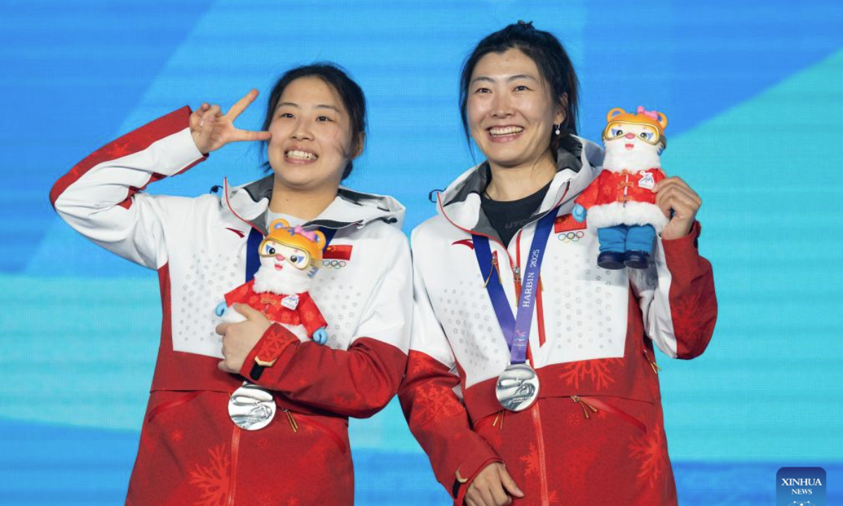 Silver medalists Chen Meiting (L)/Xu Mengtao of China pose during the awarding ceremony for the freestyle skiing women's aerials synchro final at the 9th Asian Winter Games in Yabuli, northeast China's Heilongjiang Province, Feb. 11, 2025. (Xinhua/Xie Jianfei)