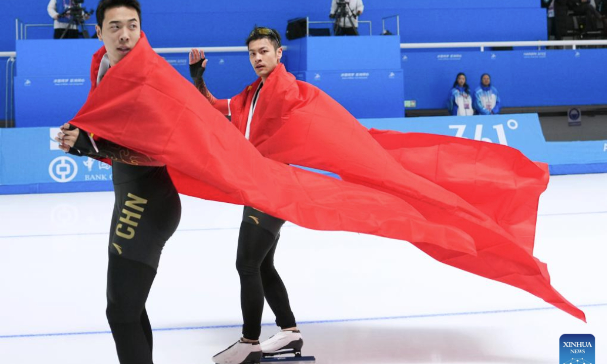 Ning Zhongyan (R) and Lian Ziwen of China celebrate after the men's 1000m final match of the speed skating event at the 9th Asian Winter Games in Harbin, northeast China's Heilongjiang Province, Feb. 11, 2025. (Xinhua/Li Yibo)