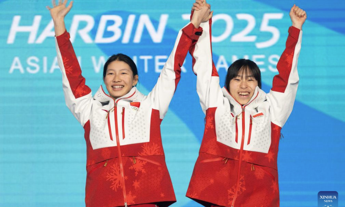 Gold medalists Feng Junxi (L)/Wang Xue of China react during the awarding ceremony for the freestyle skiing women's aerials synchro final at the 9th Asian Winter Games in Yabuli, northeast China's Heilongjiang Province, Feb. 11, 2025. (Xinhua/Xie Jianfei)