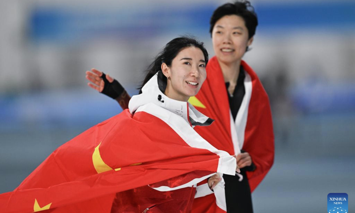 Han Mei (L) and Yin Qi of China celebrate after the women's 1000m final match of the speed skating event at the 9th Asian Winter Games in Harbin, northeast China's Heilongjiang Province, Feb. 11, 2025. (Xinhua/Chen Zhenhai)