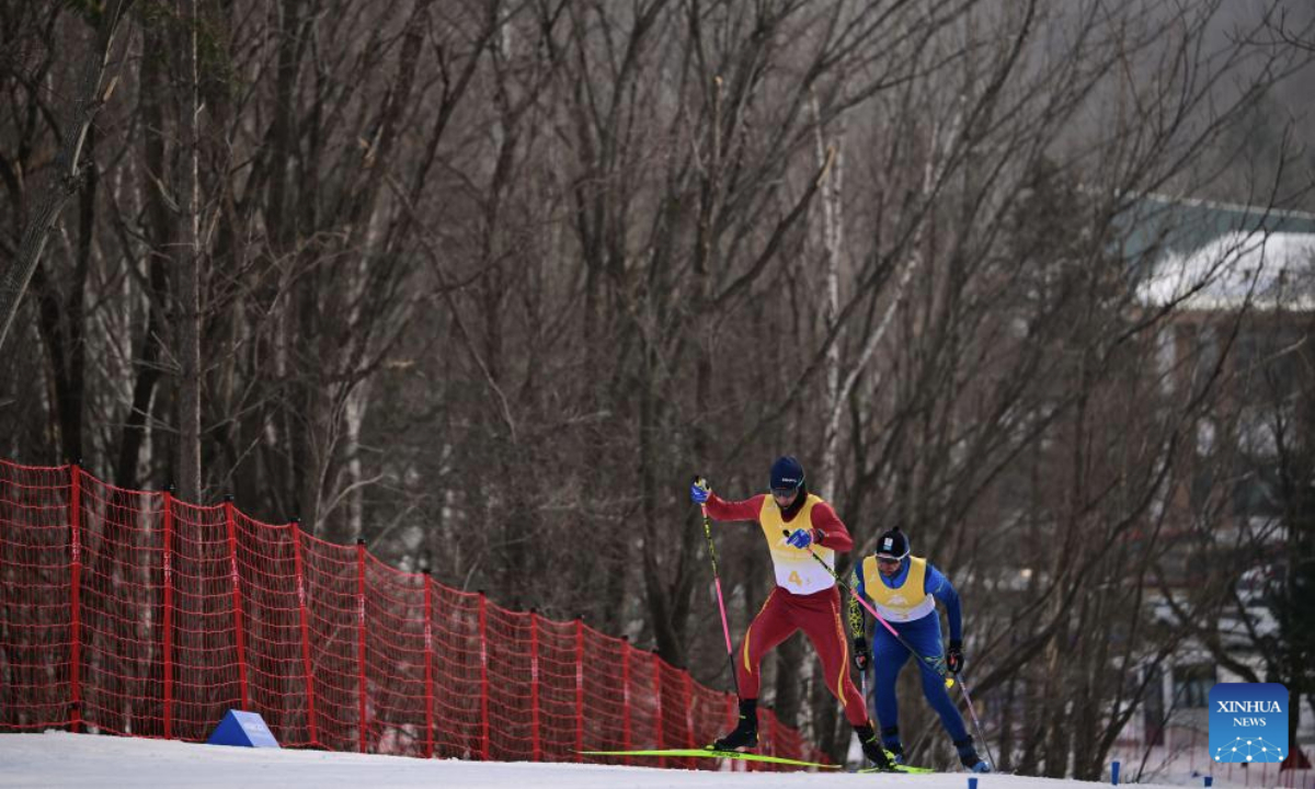 Bao Lin (L) of China competes during the Cross-Country Skiing men's 4x7.5km relay match at the 9th Asian Winter Games in Yabuli, northeast China's Heilongjiang Province, Feb. 12, 2025. (Xinhua/Zhang Long)