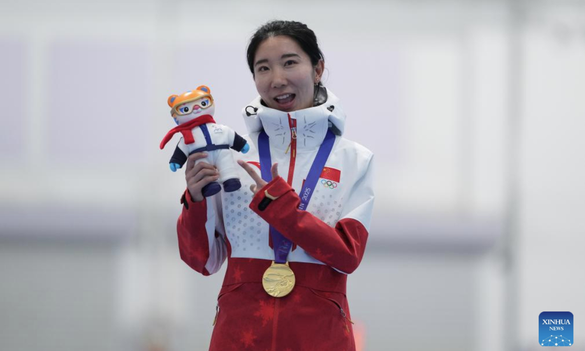 Gold medalist Han Mei of China poses for photos during the awarding ceremony of the women's 1000m final match of the speed skating event at the 9th Asian Winter Games in Harbin, northeast China's Heilongjiang Province, Feb. 11, 2025. (Xinhua/Li Yibo)