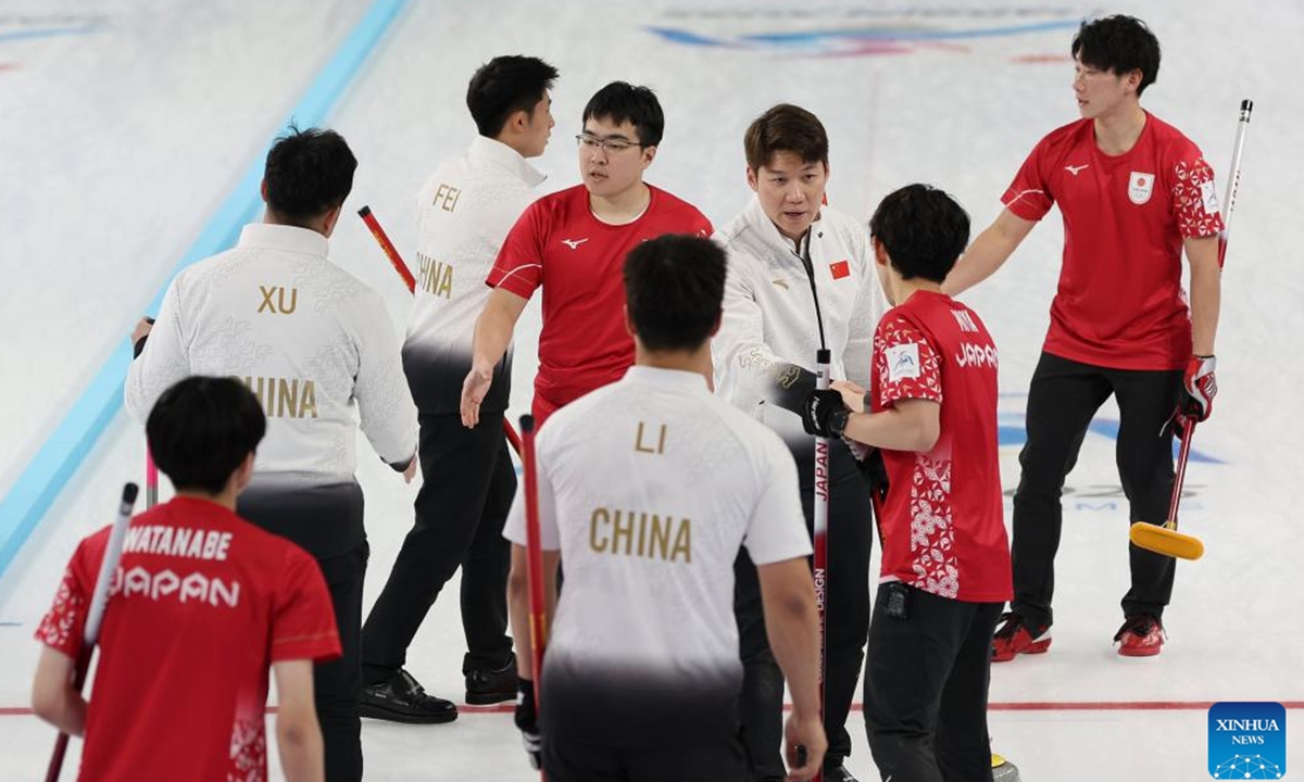 Athletes shake hands after the curling men's round robin group B session 13 match between Japan and China at the 9th Asian Winter Games in Harbin, northeast China's Heilongjiang Province, Feb. 12, 2025. (Xinhua/Hu Xingyu)