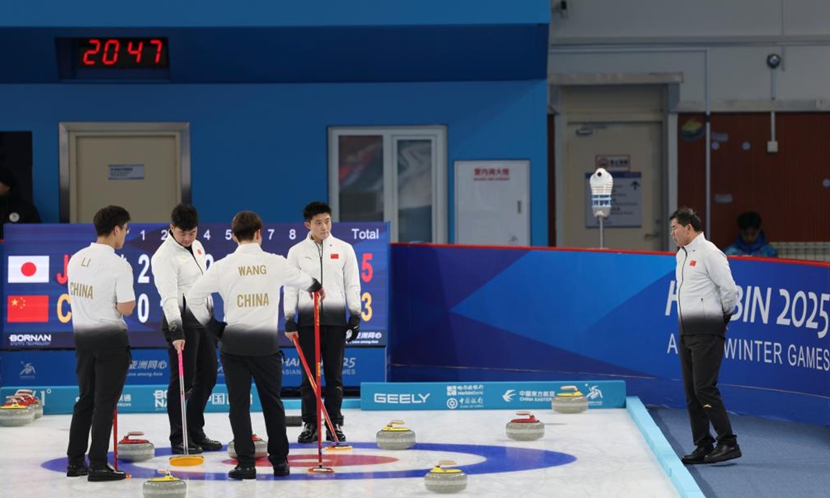 Coach Tan Weidong (R) of China gives instructions to athletes during the curling men's round robin group B session 13 match between Japan and China at the 9th Asian Winter Games in Harbin, northeast China's Heilongjiang Province, Feb. 12, 2025. (Xinhua/Hu Xingyu)