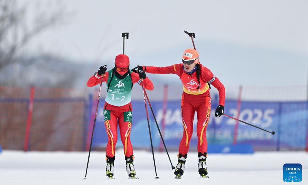 Wen Ying (L) and Tang Jialin of China compete during the Biathlon women's 4x6km relay match at the 9th Asian Winter Games in Yabuli, northeast China's Heilongjiang Province, Feb. 13, 2025. (Xinhua/Wu Zhizun)