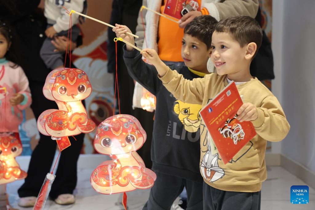 Boys pose for photos with snake-shaped lanterns at a Lantern Festival celebration event in Rabat, Morocco, on Feb. 12, 2025. (Photo: Xinhua)