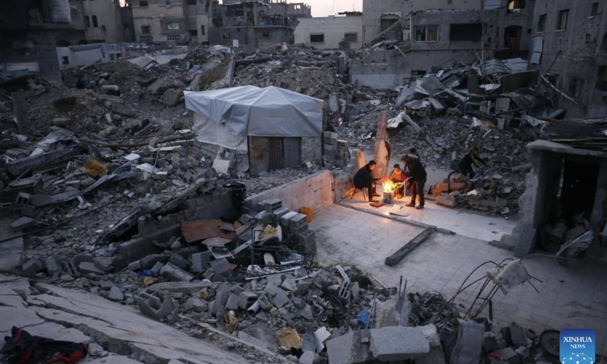 Palestinians are seen living among the rubble of destroyed houses in Jabalia in the northern Gaza Strip, Feb. 16, 2025. (Photo by Mahmoud Zaki/Xinhua)