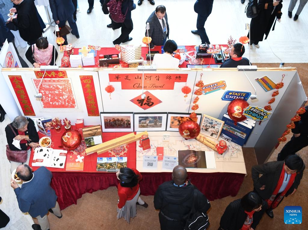 People participate in an event celebrating the Chinese Spring Festival at the Palais des Nations in Geneva, Switzerland, Feb. 12, 2025. This event featuring Tai Chi fan performances, paper-cutting, calligraphy, and lantern riddles was held here on Wednesday. It was organized by the Permanent Mission of China to the UN Office in Geneva and other international organizations in Switzerland. (Photo: Xinhua)