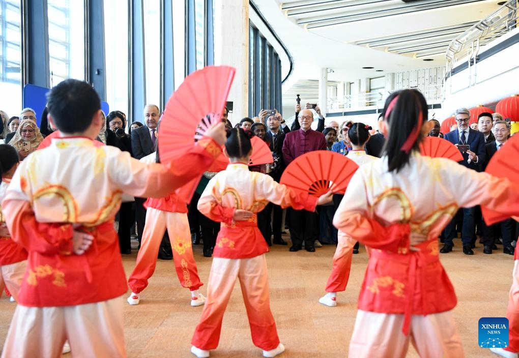 Guests watch Tai Chi fan performance during an event celebrating the Chinese Spring Festival at the Palais des Nations in Geneva, Switzerland, Feb. 12, 2025. This event featuring Tai Chi fan performances, paper-cutting, calligraphy, and lantern riddles was held here on Wednesday. It was organized by the Permanent Mission of China to the UN Office in Geneva and other international organizations in Switzerland. (Photo: Xinhua)