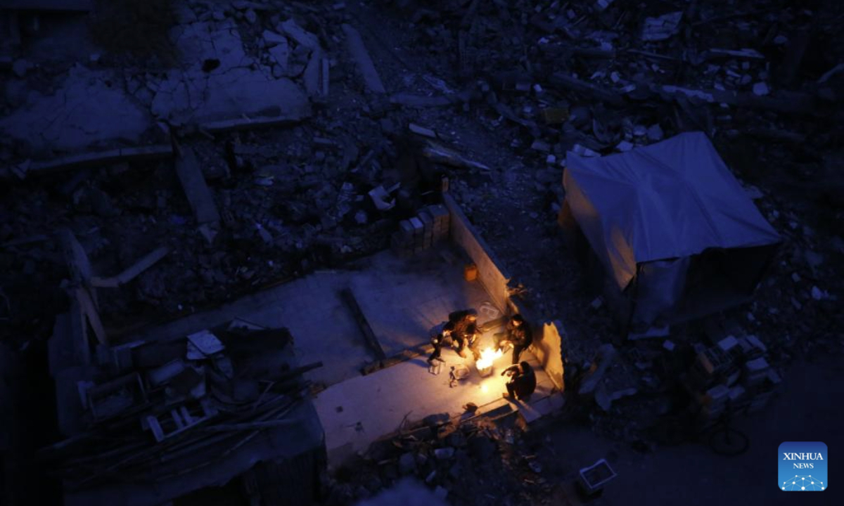 Palestinians are seen living among the rubble of destroyed houses in Jabalia in the northern Gaza Strip, Feb. 16, 2025. (Photo by Mahmoud Zaki/Xinhua)