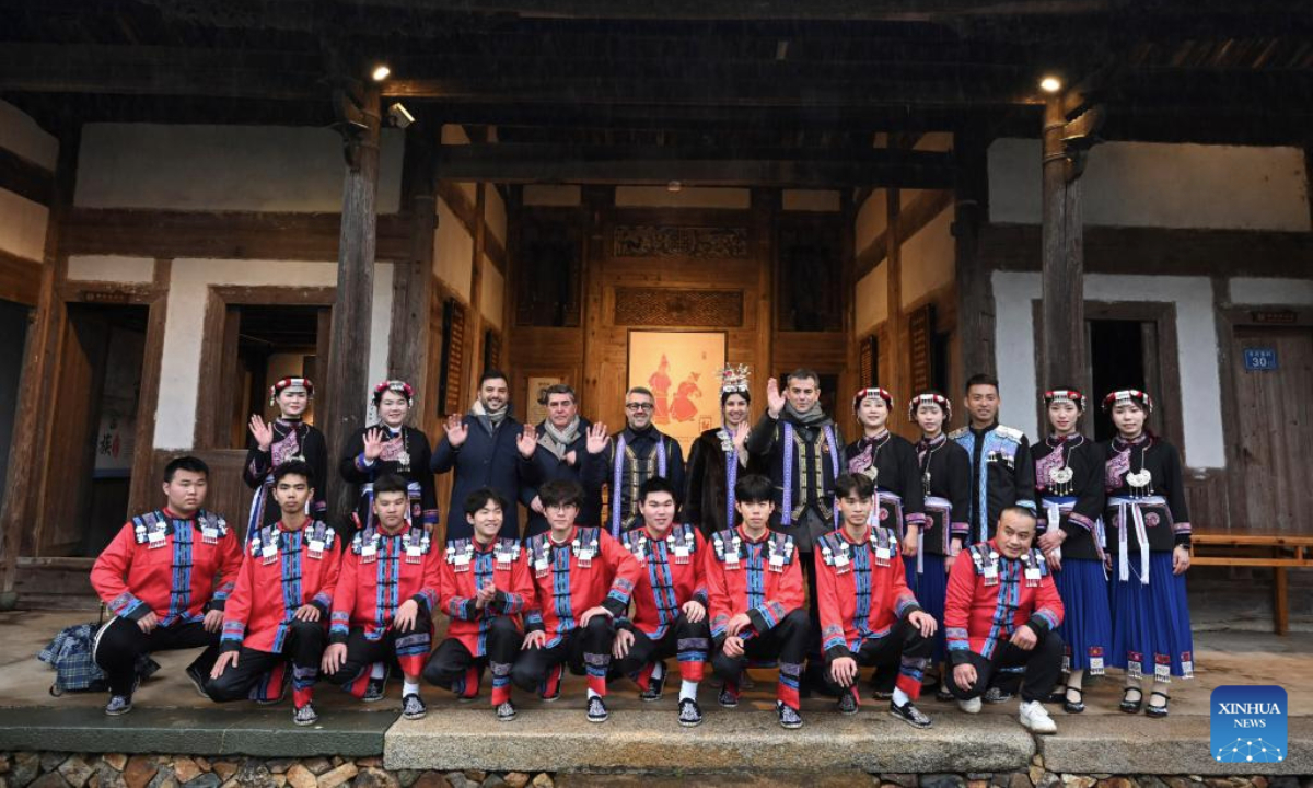 Performers take a group photo with Italian guests in Banyueli Village of Xinan Town, Xiapu County, southeast China's Fujian Province, Feb. 20, 2025. A delegation from Sardinia, Italy visited the village on Thursday, experiencing the unique She ethnic group culture and customs. (Xinhua/Jiang Kehong)