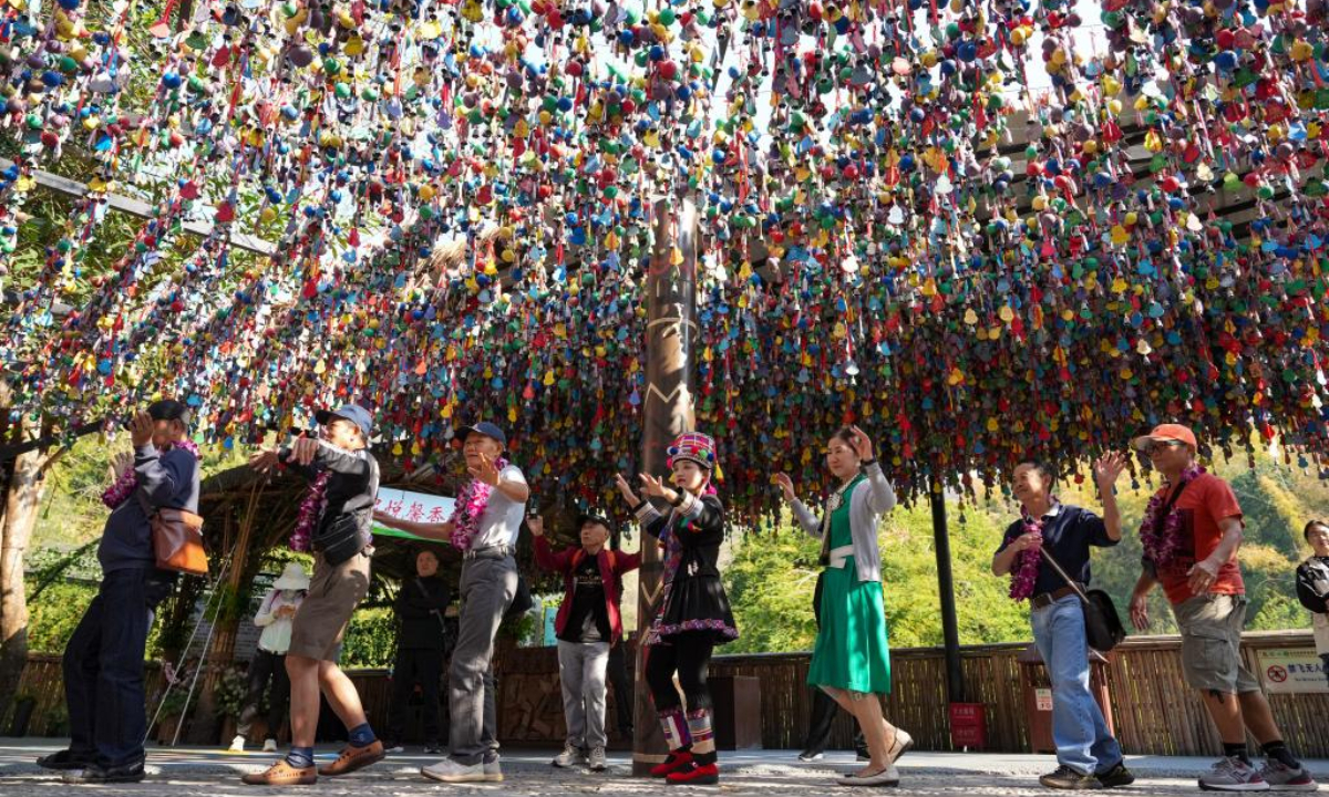 Tourists from a tour group, the first one from the Association of Southeast Asian Nations (ASEAN) member states since China introduced its new visa relaxation policy, dance with Chinese tourists and staff members at a scenic spot in Xishuangbanna Dai Autonomous Prefecture, southwest China's Yunnan Province, Feb. 19, 2025. (Xinhua/Chen Xinbo)