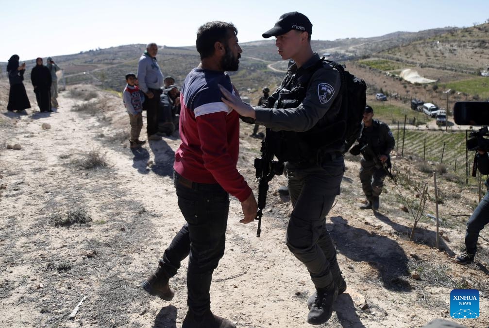 Israeli forces take security measures as Israeli army bulldozers demolish houses belonging to Palestinians in the Masafer Yatta district, south of the West Bank city of Hebron, on Feb. 18, 2025. (Photo: Xinhua)