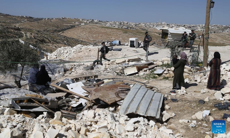 Israeli forces take security measures as Israeli army bulldozers demolish houses belonging to Palestinians in the Masafer Yatta district, south of the West Bank city of Hebron, on Feb. 18, 2025. (Photo: Xinhua)