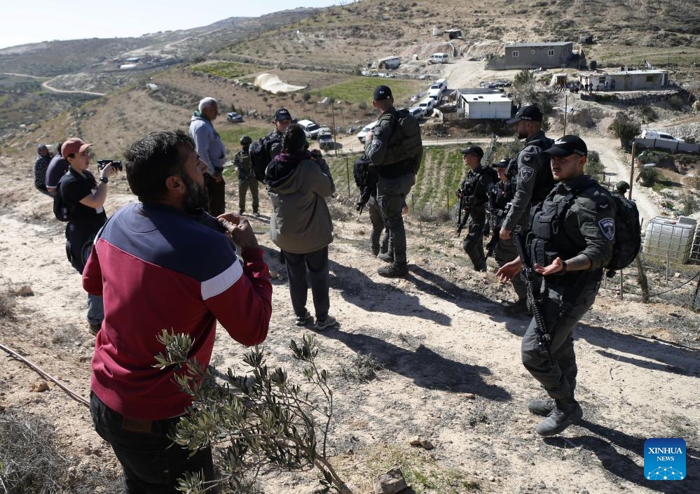 Israeli forces take security measures as Israeli army bulldozers demolish houses belonging to Palestinians in the Masafer Yatta district, south of the West Bank city of Hebron, on Feb. 18, 2025. (Photo: Xinhua)