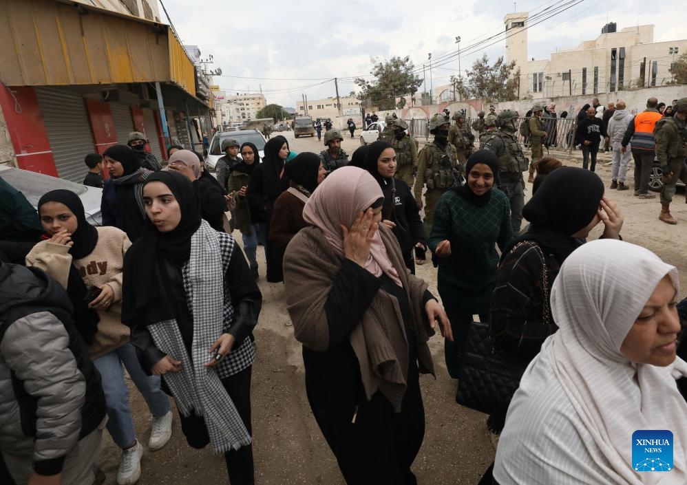 Israeli soldiers prevent displaced Palestinians in the West Bank city of Jenin from getting back to their houses in the Jenin refugee camp, on Feb. 19, 2025. Palestine on Wednesday accused Israel of waging a comprehensive war on the West Bank, particularly in the northern regions, involving crimes of murder, displacement, and the destruction of property. (Photo: Xinhua)